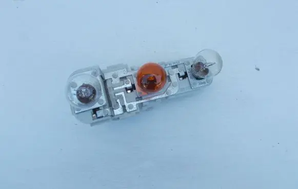 Tail light bulb cover holder