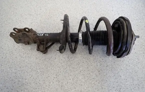 KIA Carens III Front shock absorber with coil spring 