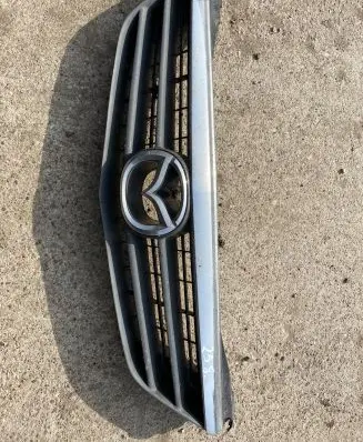 Mazda 626 Front bumper upper radiator grill GG2M50712