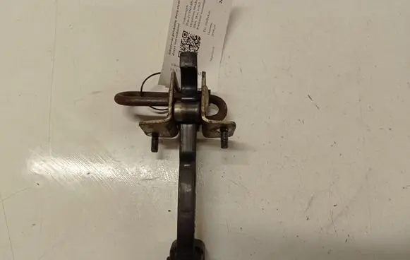 Front door check strap stopper