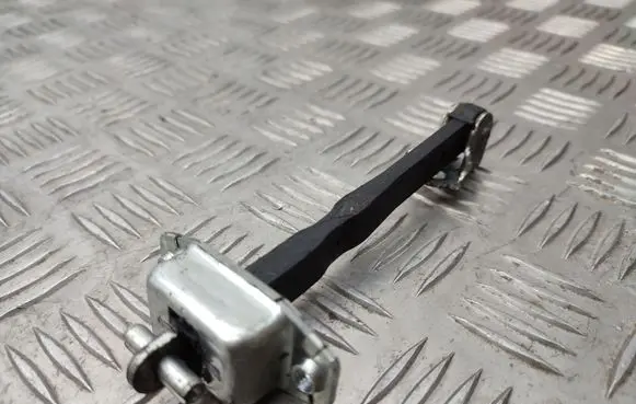 Front door check strap stopper
