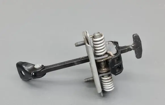 Front door check strap stopper