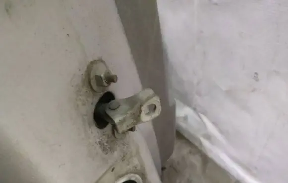Front door check strap stopper