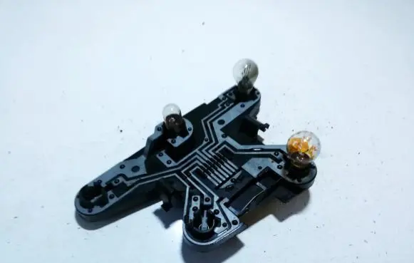 Tail light bulb cover holder