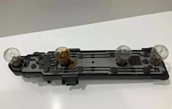 Tail light bulb cover holder