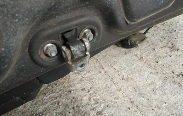 Front door check strap stopper