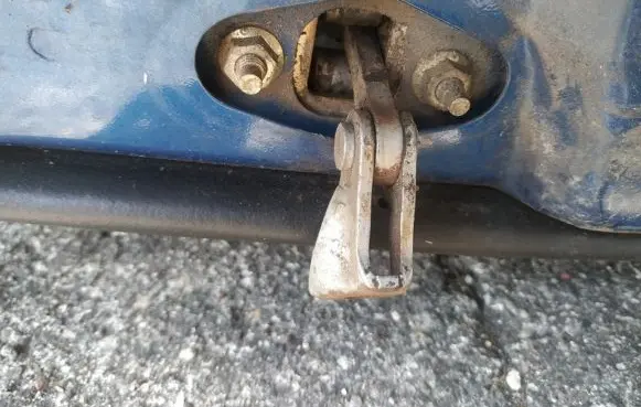 Front door check strap stopper