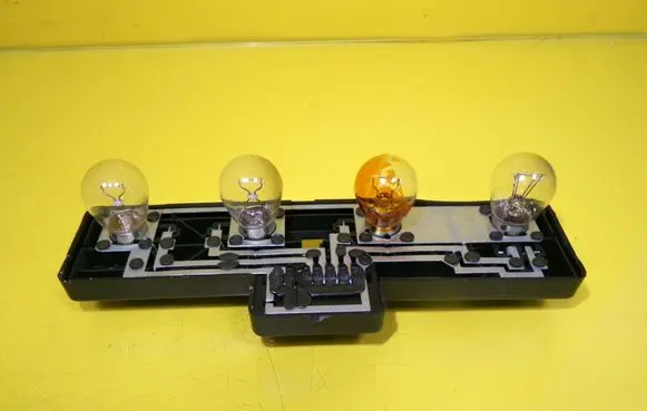 Tail light bulb cover holder