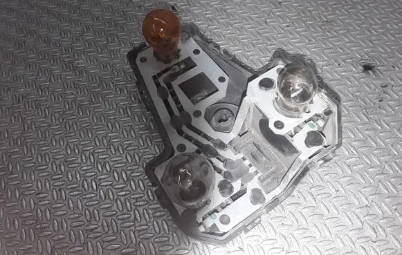 Tail light bulb cover holder