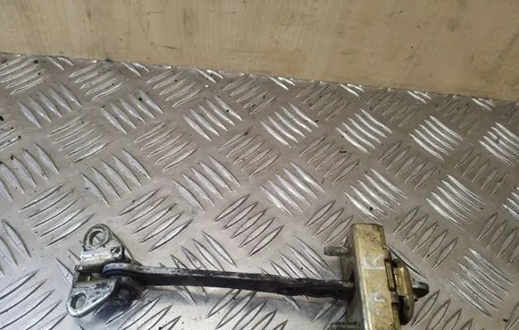 Front door check strap stopper