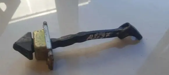 Front door check strap stopper
