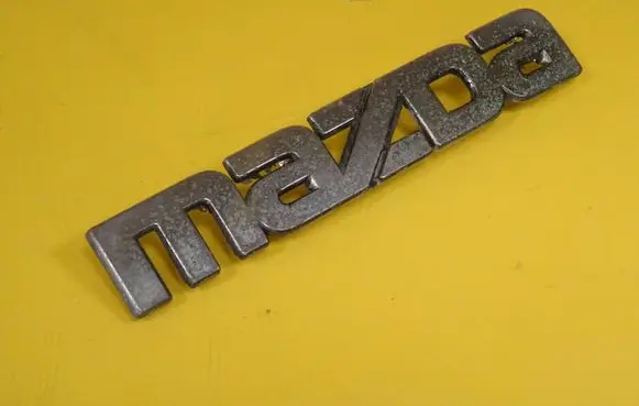 Mazda 121 SM Manufacturer badge logo/emblem 