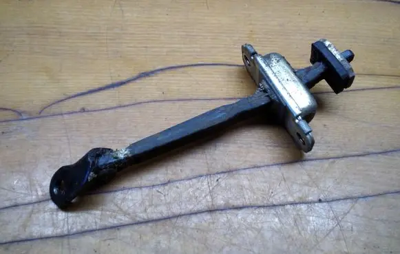 Front door check strap stopper