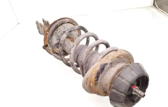 Suzuki Swift I Front shock absorber with coil spring