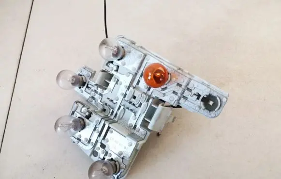 Tail light bulb cover holder