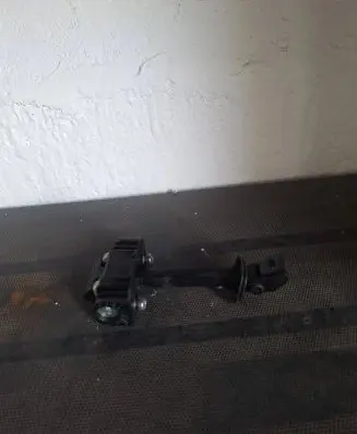 Front door check strap stopper