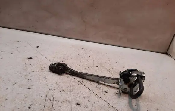 Front door check strap stopper
