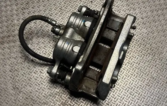 Subaru Legacy VII Front brake caliper 0F00A
