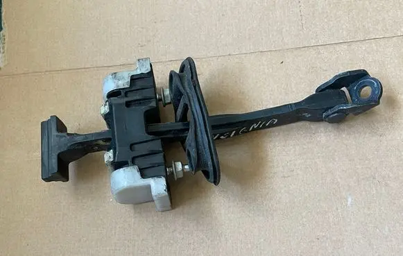 Front door check strap stopper