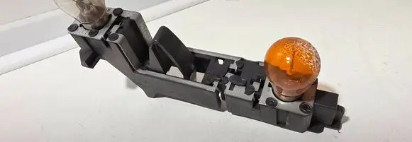 Tail light bulb cover holder