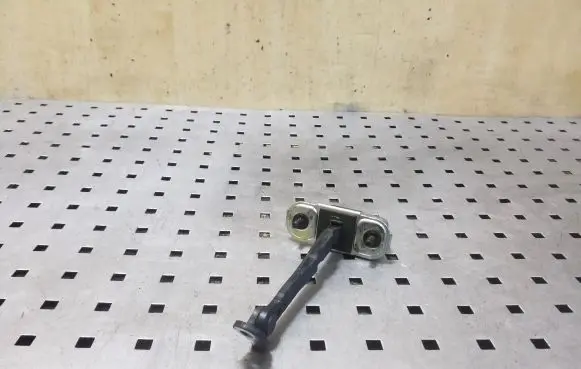 Front door check strap stopper