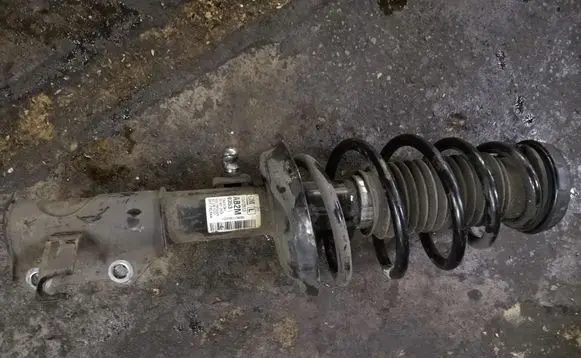 Opel Astra J Front shock absorber with coil spring 13412613