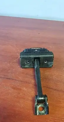 Front door check strap stopper