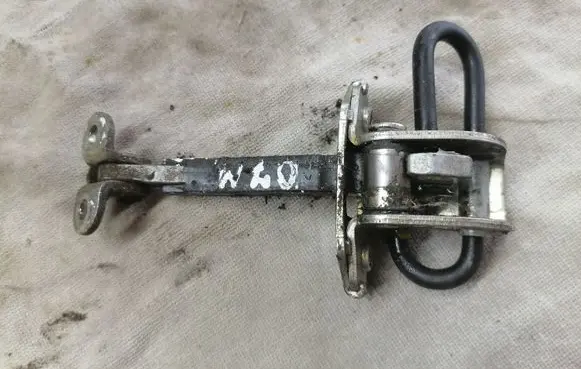 Front door check strap stopper