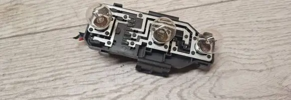 Tail light bulb cover holder