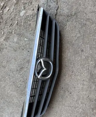 Mazda 626 Front bumper upper radiator grill GG2M50712