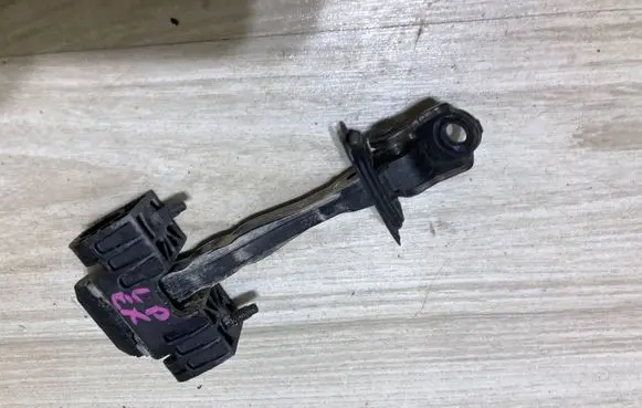 Front door check strap stopper