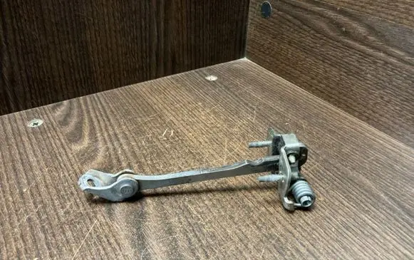 Front door check strap stopper