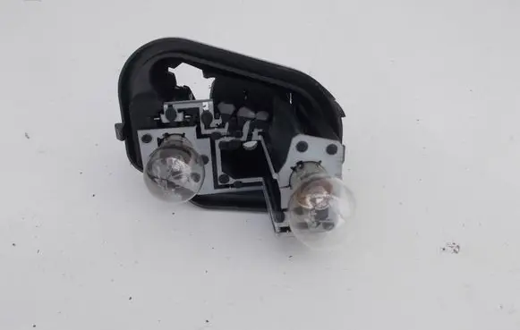 Tail light bulb cover holder