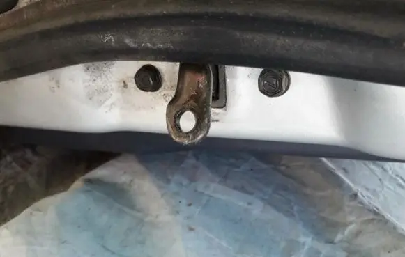 Front door check strap stopper