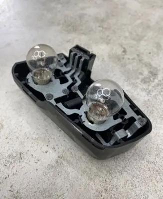 Tail light bulb cover holder