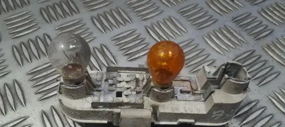 Tail light bulb cover holder