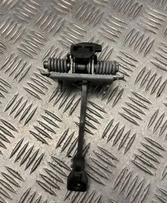 Front door check strap stopper