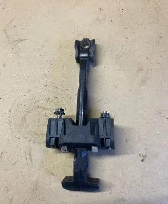 Front door check strap stopper