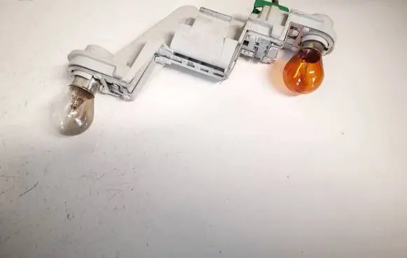 Tail light bulb cover holder