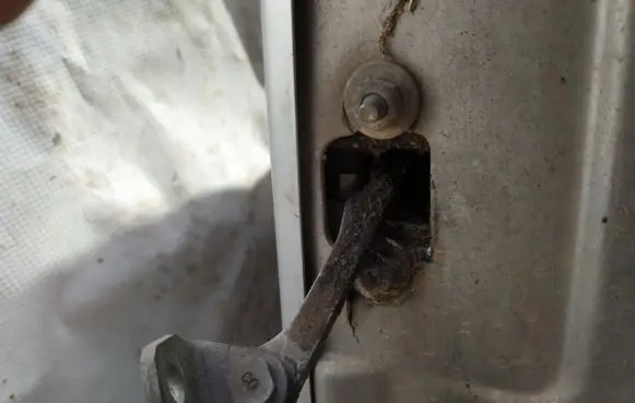 Front door check strap stopper