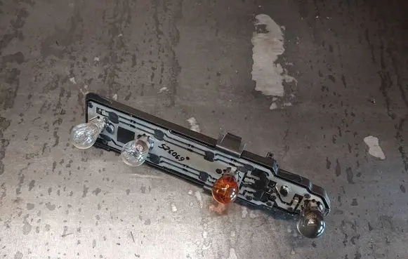 Tail light bulb cover holder