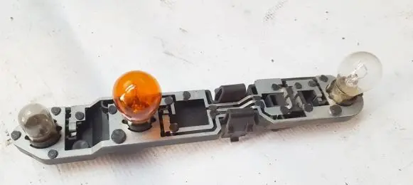 Tail light bulb cover holder