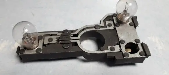 Tail light bulb cover holder