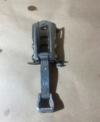 Front door check strap stopper