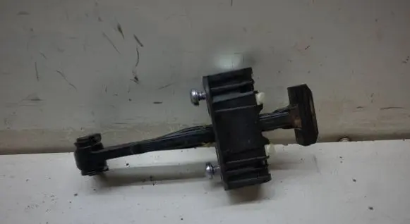 Front door check strap stopper