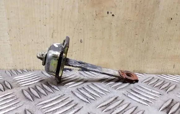 Front door check strap stopper
