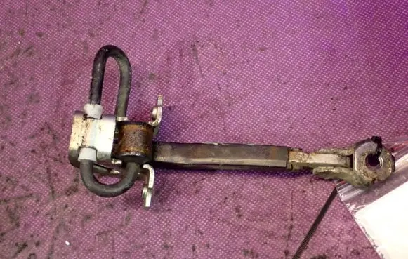 Front door check strap stopper