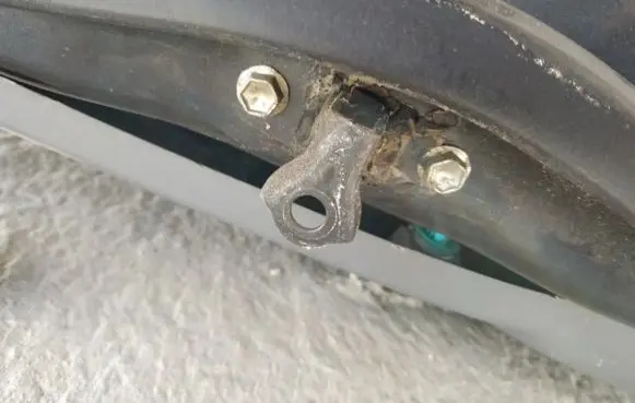 Front door check strap stopper