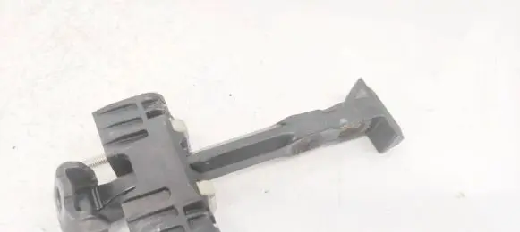Front door check strap stopper