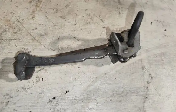 Front door check strap stopper